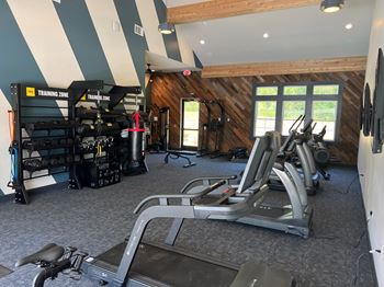 A gym with treadmills and exercise equipment.